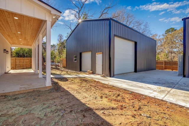 detached garage featuring fence