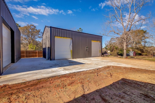 detached garage featuring fence