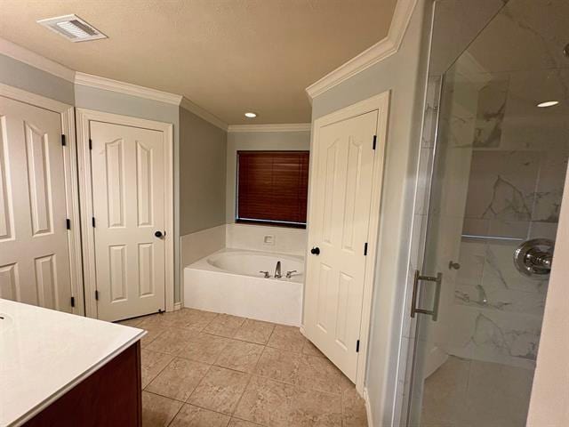 bathroom featuring a bath, visible vents, crown molding, vanity, and a stall shower