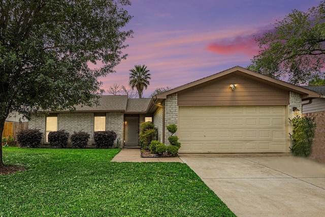 5427 Cairnleigh Dr, Houston, TX 77084 - mid-century home featuring a garage, concrete driveway, a lawn, and brick siding