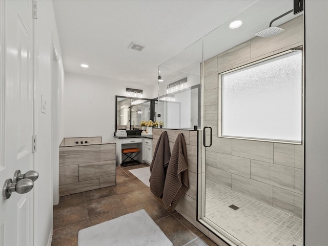 bathroom with a stall shower, visible vents, recessed lighting, and vanity