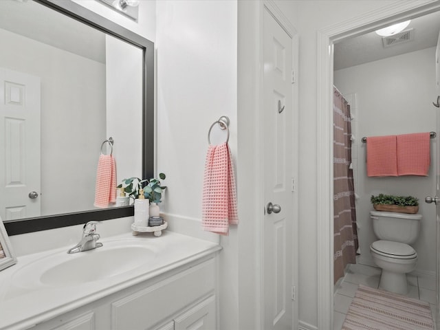 bathroom with tile patterned floors, visible vents, toilet, and vanity