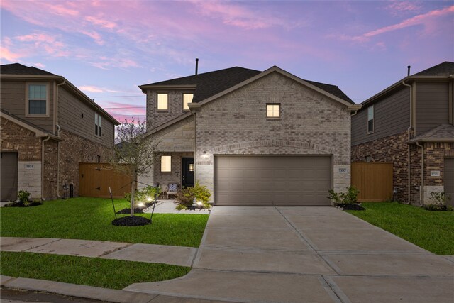 1100 Greenshank Dr, Katy, TX 77493 - view of front of property featuring fence, driveway, a front yard, brick siding, and a garage
