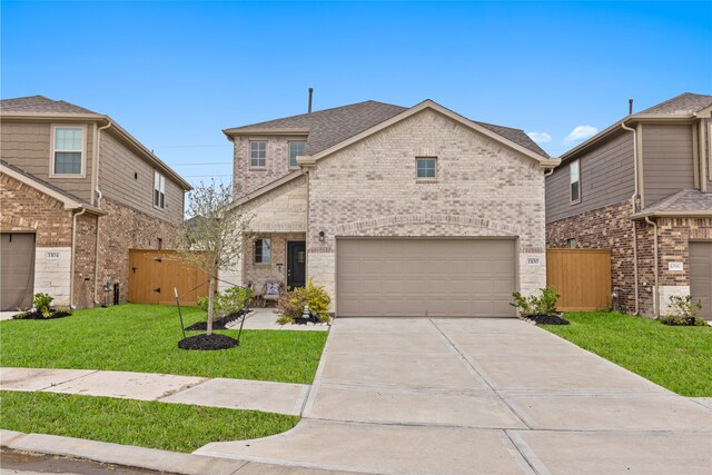 1100 Greenshank Dr, Katy, TX 77493 - view of front facade with a front yard, fence, brick siding, and concrete driveway