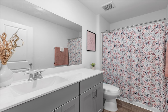 1100 Greenshank Dr, Katy, TX 77493 - bathroom featuring toilet, vanity, a shower with curtain, wood finished floors, and visible vents