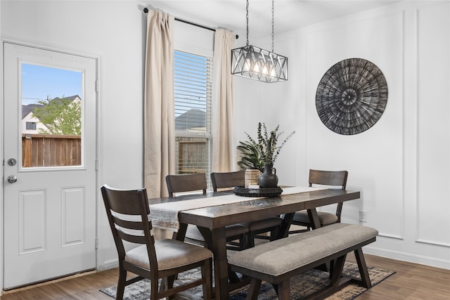 1100 Greenshank Dr, Katy, TX 77493 - dining area with a decorative wall, a notable chandelier, baseboards, and wood finished floors