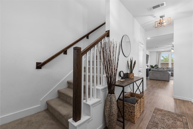 1100 Greenshank Dr, Katy, TX 77493 - stairs featuring baseboards, visible vents, and wood finished floors