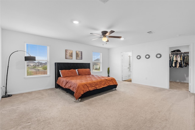 1100 Greenshank Dr, Katy, TX 77493 - bedroom with baseboards, visible vents, a walk in closet, and light carpet