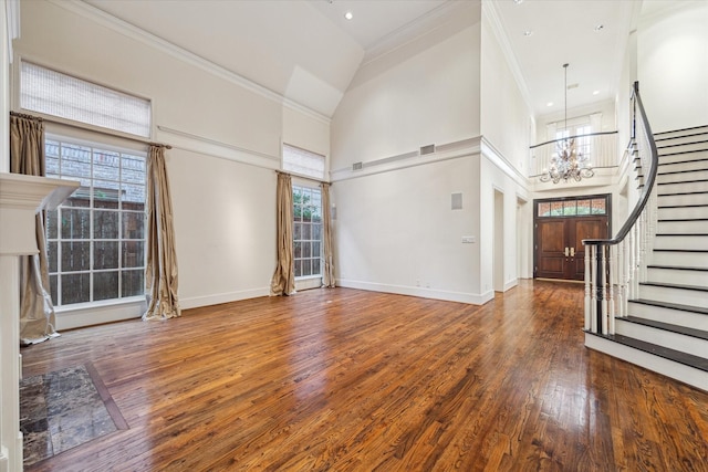 5079 Cedar Creek Dr, Houston, TX 77056 - foyer entrance with a chandelier, a high ceiling, stairs, wood finished floors, and baseboards