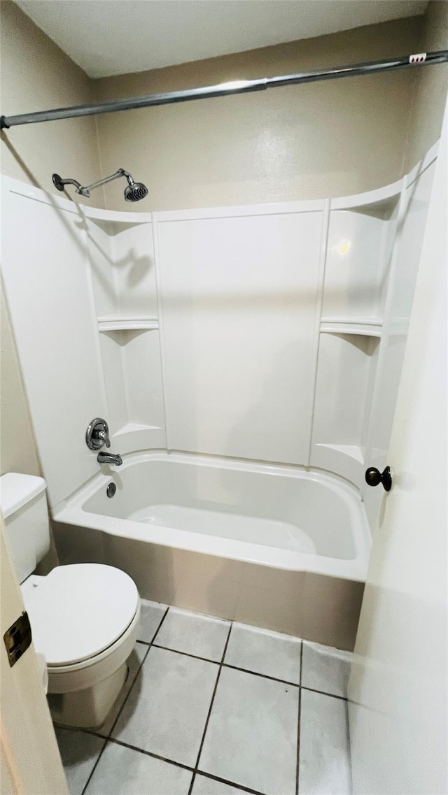 full bath featuring tile patterned floors, shower / washtub combination, and toilet