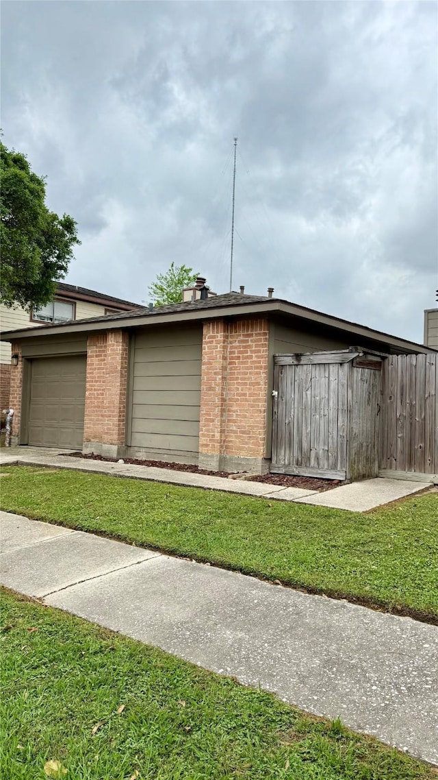 view of home's exterior featuring a yard and brick siding