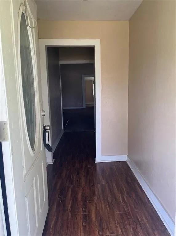 405 E Main St, Bishop, TX 78343 - hallway featuring dark wood-type flooring and baseboards