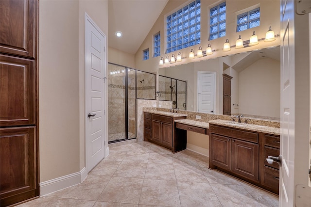 107 Lake View Loop, Fulshear, TX 77441 - bathroom featuring a stall shower, vaulted ceiling, baseboards, two vanities, and tile patterned floors