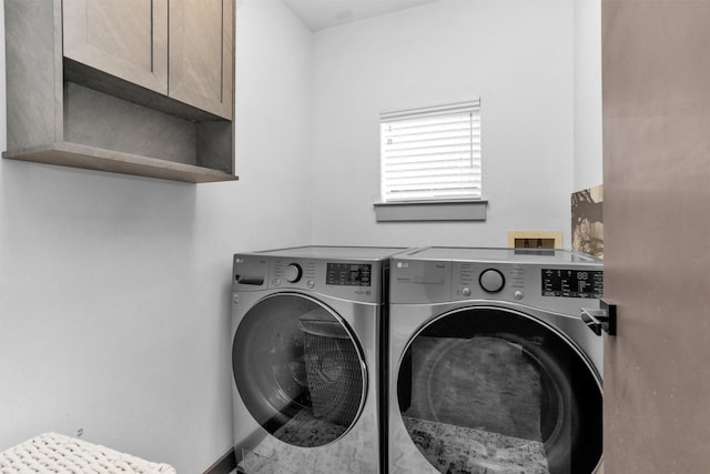 618 Lester St, Houston, TX 77007 - washroom featuring washer and clothes dryer and cabinet space