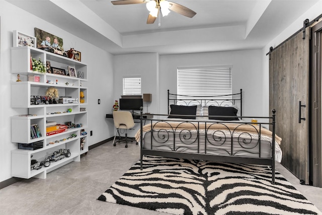 618 Lester St, Houston, TX 77007 - bedroom featuring a raised ceiling, a barn door, a ceiling fan, and baseboards