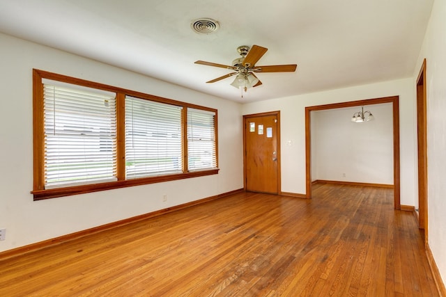 interior space with baseboards, visible vents, hardwood / wood-style flooring, and a healthy amount of sunlight
