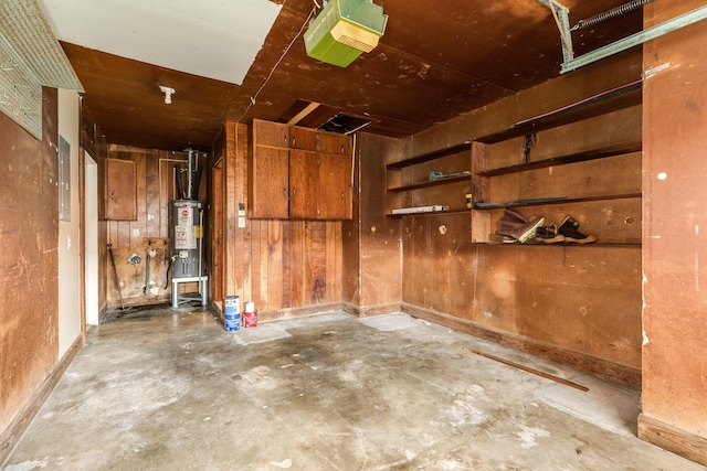 garage with water heater, electric panel, and a garage door opener