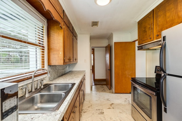 kitchen featuring light countertops, stainless steel appliances, under cabinet range hood, a sink, and visible vents