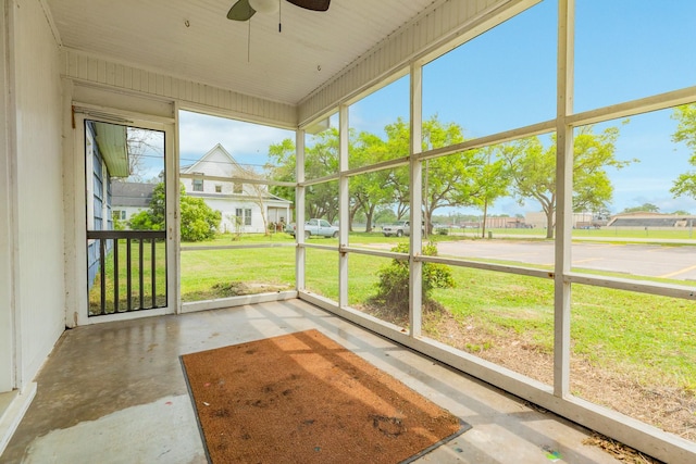 unfurnished sunroom with a ceiling fan