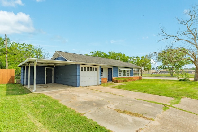 view of front of home with fence, an attached garage, a front lawn, driveway, and a carport