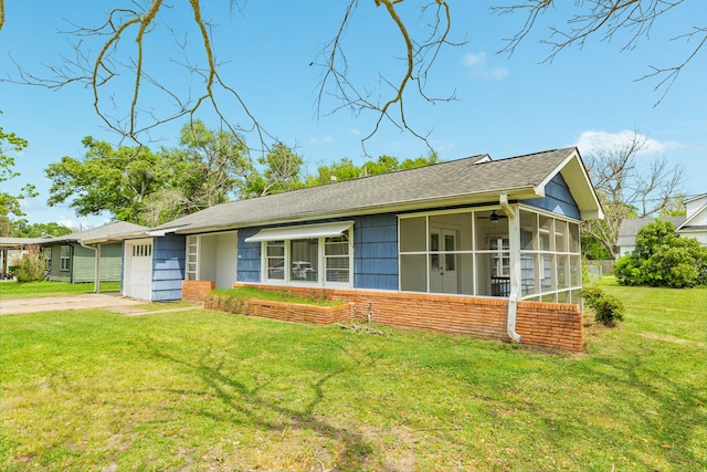 ranch-style home with a front lawn, a shingled roof, and a sunroom
