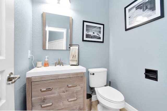 2019 Doolan Dr, Conroe, TX 77301 - bathroom featuring toilet, vanity, and baseboards