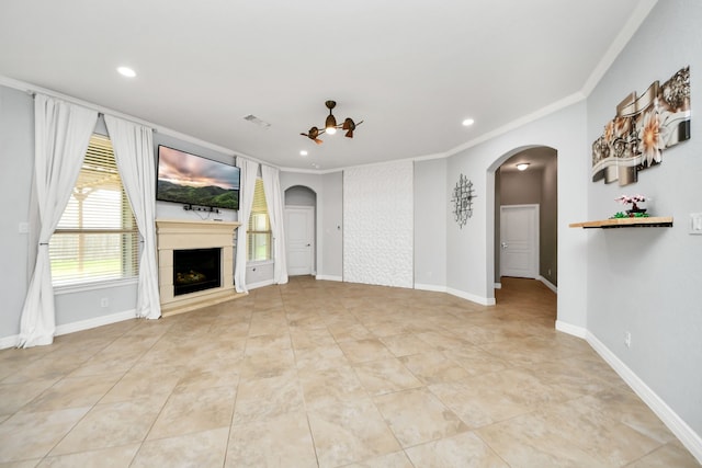 2019 Doolan Dr, Conroe, TX 77301 - unfurnished living room featuring a fireplace, recessed lighting, ornamental molding, and arched walkways