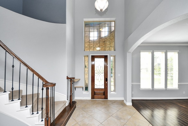2019 Doolan Dr, Conroe, TX 77301 - entryway featuring baseboards, stairs, arched walkways, and a high ceiling