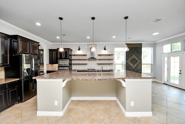 2019 Doolan Dr, Conroe, TX 77301 - kitchen featuring a healthy amount of sunlight, open shelves, refrigerator with ice dispenser, and a kitchen bar
