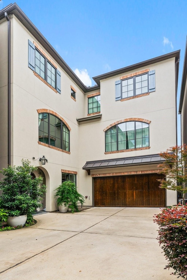 1705 Michigan St, Houston, TX 77006 - view of front of home with a garage, stucco siding, and driveway