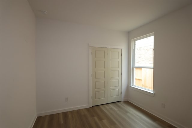 8526 Pier Cove Dr, Cypress, TX 77433 - unfurnished room with wood finished floors, healthy amount of natural light, and a smoke detector