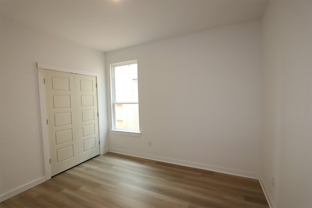 8526 Pier Cove Dr, Cypress, TX 77433 - unfurnished bedroom with wood finished floors and baseboards