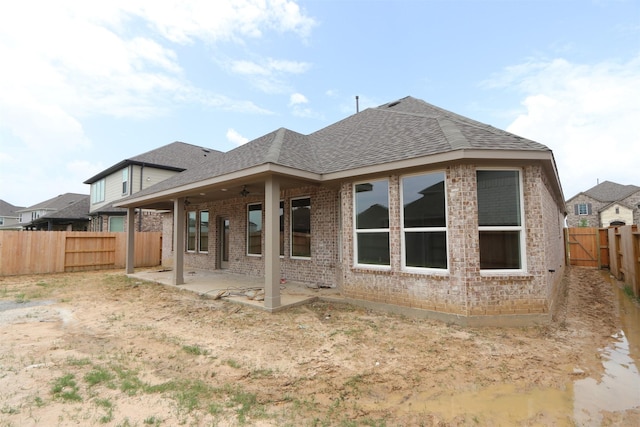 8526 Pier Cove Dr, Cypress, TX 77433 - back of house with a shingled roof, brick siding, a patio area, and a fenced backyard