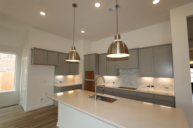 8526 Pier Cove Dr, Cypress, TX 77433 - kitchen featuring gray cabinetry, dark wood-style floors, tasteful backsplash, recessed lighting, and decorative light fixtures