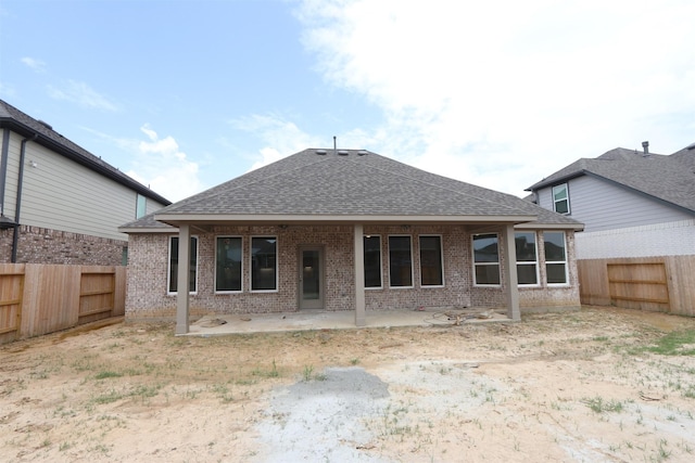 8526 Pier Cove Dr, Cypress, TX 77433 - rear view of house featuring a shingled roof, a fenced backyard, a patio, and brick siding