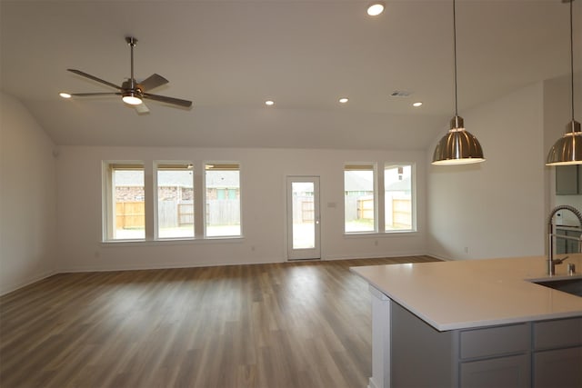 8526 Pier Cove Dr, Cypress, TX 77433 - unfurnished living room with lofted ceiling, healthy amount of natural light, wood finished floors, recessed lighting, and ceiling fan