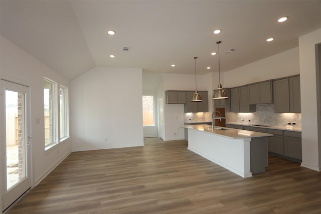 8526 Pier Cove Dr, Cypress, TX 77433 - kitchen with gray cabinets, recessed lighting, healthy amount of natural light, backsplash, and vaulted ceiling
