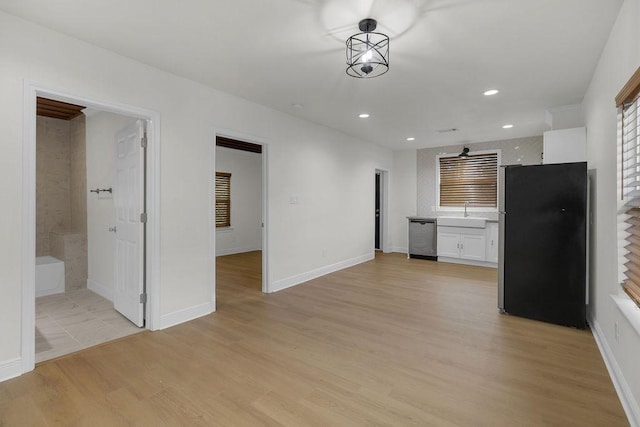 2831 Jones St, Houston, TX 77026 - unfurnished living room featuring light wood-type flooring and recessed lighting
