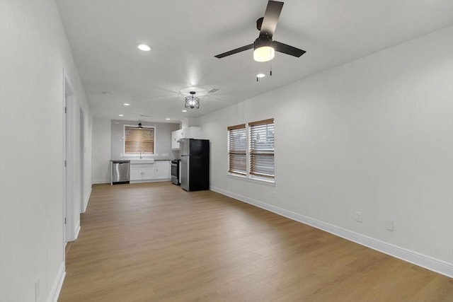 2831 Jones St, Houston, TX 77026 - unfurnished living room with light wood-type flooring, recessed lighting, and ceiling fan