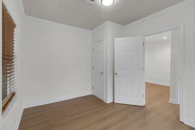 2831 Jones St, Houston, TX 77026 - unfurnished bedroom with wood finished floors, crown molding, and a closet