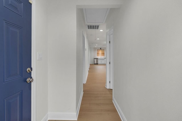 2831 Jones St, Houston, TX 77026 - hallway featuring attic access, light wood-style flooring, and recessed lighting