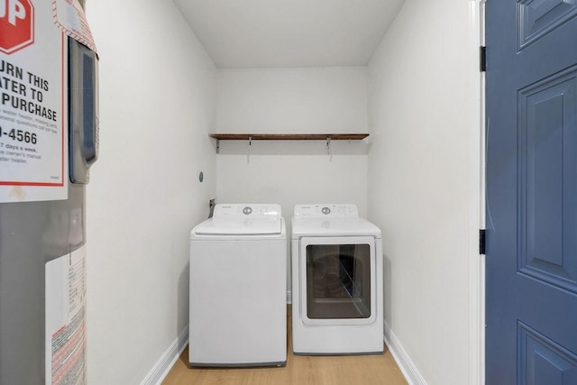 2831 Jones St, Houston, TX 77026 - laundry room featuring washer and clothes dryer, water heater, and light wood-style floors