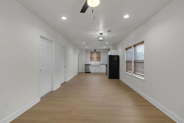 2831 Jones St, Houston, TX 77026 - unfurnished living room featuring ceiling fan, light wood-style flooring, and recessed lighting