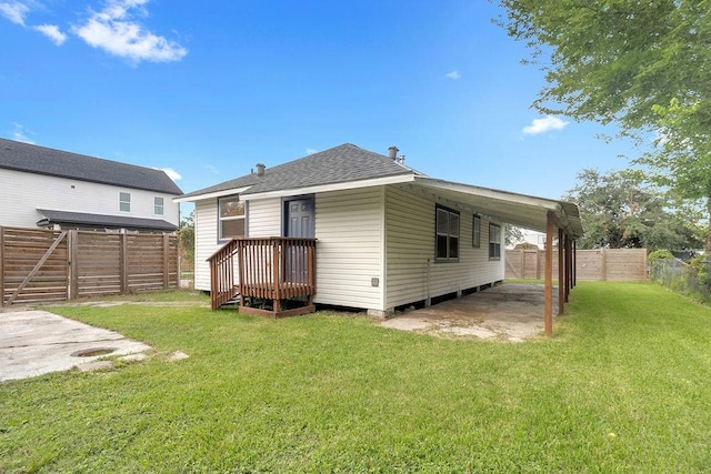 2831 Jones St, Houston, TX 77026 - back of house with a fenced backyard, roof with shingles, and a carport