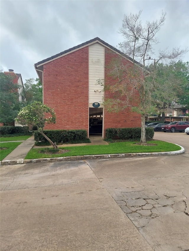 view of building exterior with uncovered parking