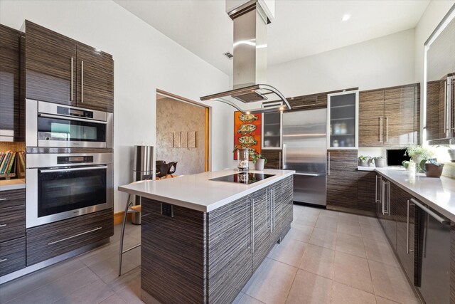 5417 Hidalgo St Unit B, Houston, TX 77056 - kitchen with appliances with stainless steel finishes, island exhaust hood, modern cabinets, and a kitchen bar