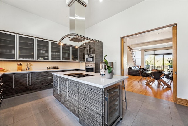 5417 Hidalgo St Unit B, Houston, TX 77056 - kitchen featuring oven, island exhaust hood, wine cooler, dark tile patterned flooring, and light countertops