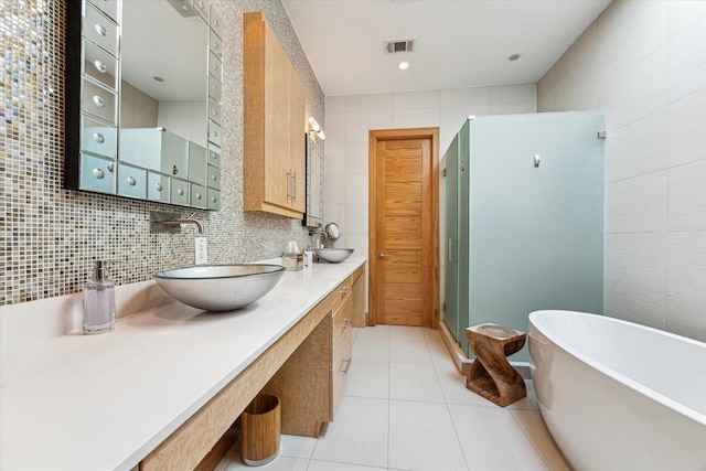 5417 Hidalgo St Unit B, Houston, TX 77056 - full bathroom featuring tile walls, a freestanding bath, tile patterned floors, a shower stall, and double vanity