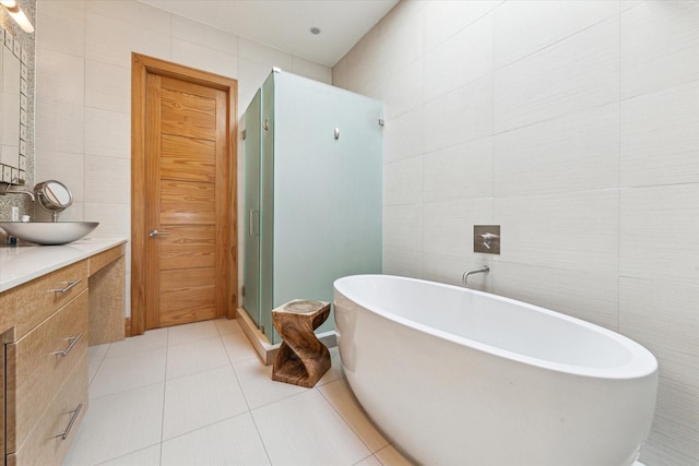 5417 Hidalgo St Unit B, Houston, TX 77056 - bathroom with tile walls, vanity, a shower stall, a freestanding tub, and tile patterned floors
