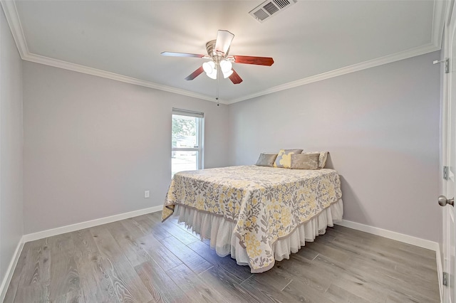 5806 Cartagena St, Houston, TX 77035 - bedroom with baseboards, ornamental molding, visible vents, and wood finished floors